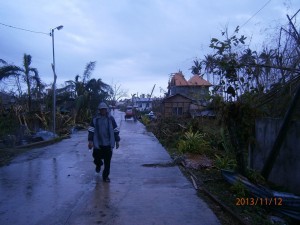 Rev. Mabini Balgos walking in a ghost town in Medellin, Cebu. The parsonage of their church was heavily hit by typhoon Yolanda. Pls. pray for him.